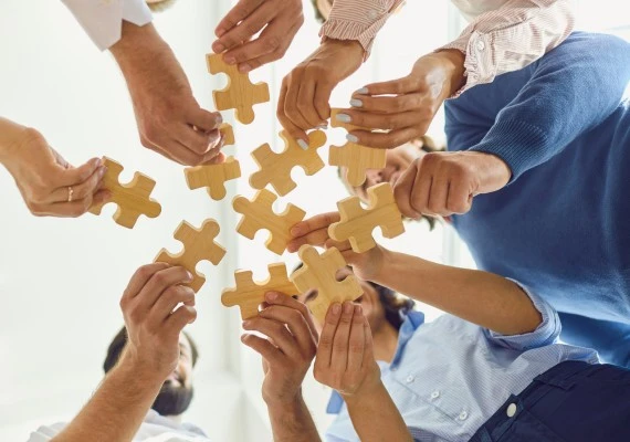 team holding puzzle pieces